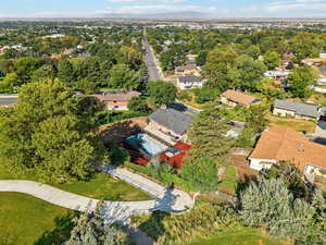 Aerial view of property and surrounding area featuring nearby suburban area