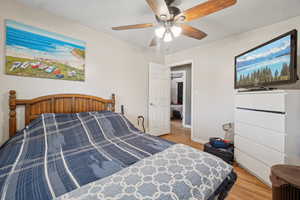 Bedroom featuring light wood-style flooring and a ceiling fan