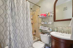 Bathroom with shower / tub combo with curtain and vanity