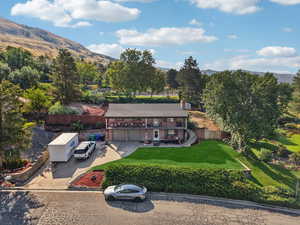 Aerial view of property and surrounding area with mountains