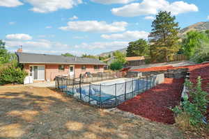 View of pool with a mountain view and a patio area