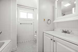 Full bathroom with vanity, shower / tub combination, and light tile patterned flooring