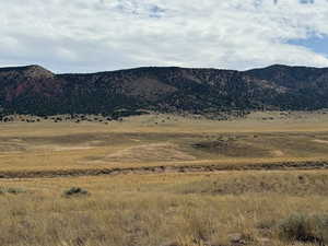 View of mountain backdrop with rural landscape