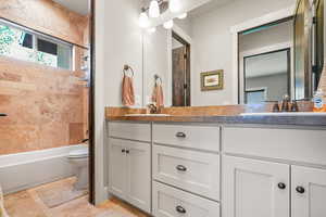 Full bath with double vanity and tub / shower combination
