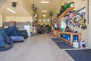 Garage with a workshop area and freestanding refrigerator