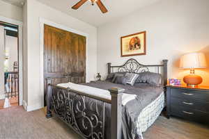 Bedroom featuring a closet, a ceiling fan, and carpet