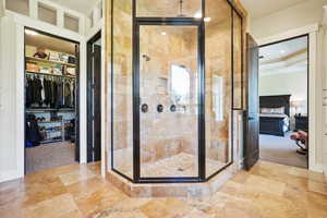 Ensuite bathroom with a stall shower and a walk in closet