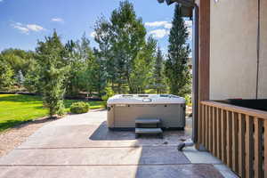 View of patio / terrace with a hot tub