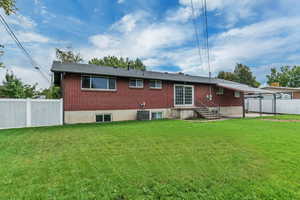 Back of property with brick siding and a patio area