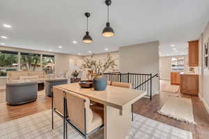 Dining space with light wood-style floors and recessed lighting