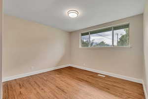 Empty room featuring light wood-style flooring and baseboards