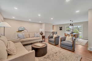 Living area with wood finished floors and recessed lighting