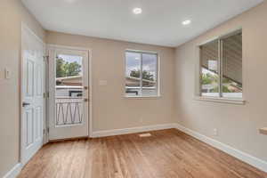 Entryway featuring wood finished floors, plenty of natural light, and recessed lighting