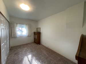 Unfurnished bedroom featuring a closet and carpet