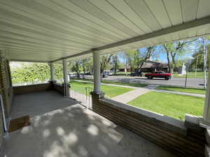 Porch featuring a yard