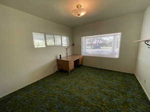 Carpeted office with baseboards