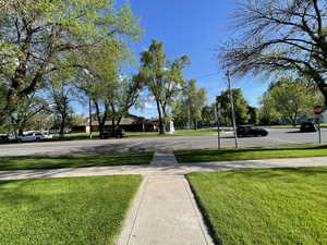 View of road with sidewalks and traffic signs
