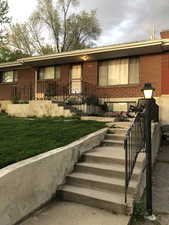 Ranch-style house with brick siding