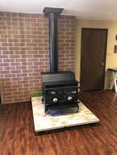 Detailed view of a wood stove and wood finished floors