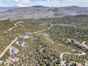 Aerial view of property and surrounding area with a mountainous background