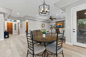 Dining space featuring a chandelier, light wood finished floors, recessed lighting, and a ceiling fan