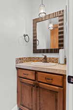 Bathroom featuring vanity and tasteful backsplash