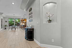 Hallway featuring light wood finished floors and recessed lighting