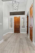 Entryway with a chandelier and light wood-type flooring