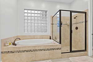 Bathroom featuring a shower stall and a garden tub