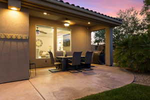Patio terrace at dusk with a patio area and outdoor dining space