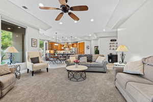Living room featuring ceiling fan, light colored carpet, and recessed lighting