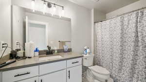 Full bathroom featuring vanity and curtained shower