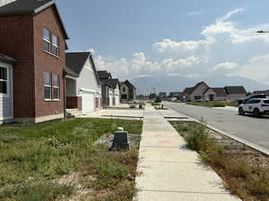 View of yard with a residential view and concrete driveway
