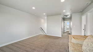 Spare room with recessed lighting and carpet