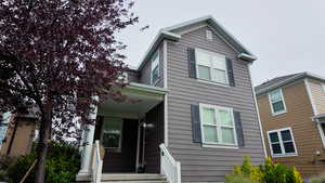 Traditional-style house featuring covered porch