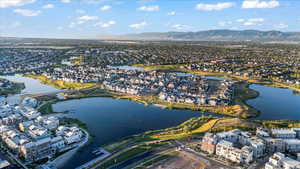 View of property location with a water and mountain view and nearby suburban area