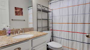 Bathroom with vanity and a shower with shower curtain