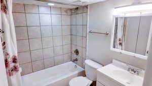 Full bath featuring shower / bathtub combination with curtain and vanity
