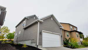 View of home's exterior featuring concrete driveway