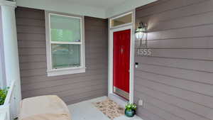 Doorway to property with covered porch