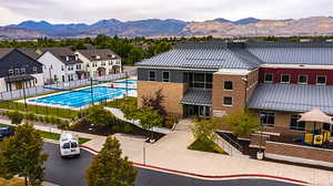 Aerial view of residential area featuring mountains and a pool area