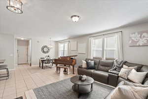 Living area with a chandelier and light tile patterned floors