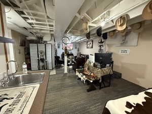 Kitchen featuring a sink and dark carpet