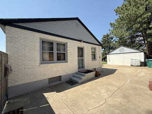 Rear view of property with an outbuilding