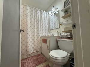 Full bathroom with light tile patterned floors, vanity, and shower / tub combo