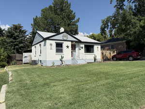 View of front of home featuring brick siding and a chimney