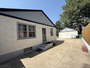 Back of property with an outbuilding
