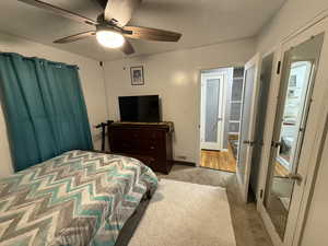 Bedroom featuring ceiling fan and carpet floors