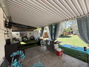 Fenced backyard featuring a patio area and grilling area
