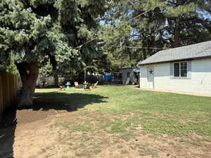 Fenced backyard with an outdoor fire pit